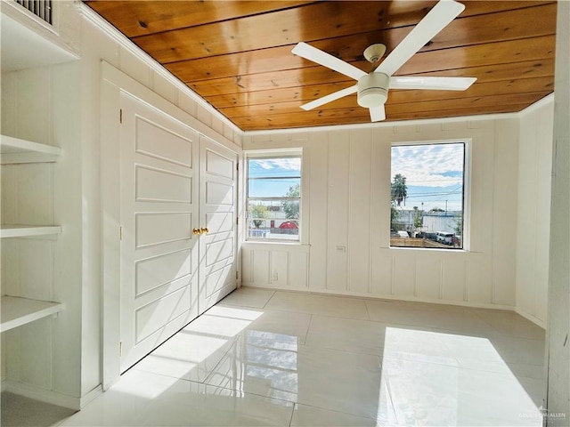 612 E Tom Landry St, Mission, TX 78572 - unfurnished room with wooden ceiling, a ceiling fan, light tile patterned floors, and a decorative wall