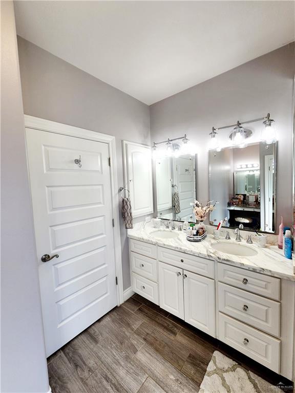 bathroom with hardwood / wood-style flooring and vanity