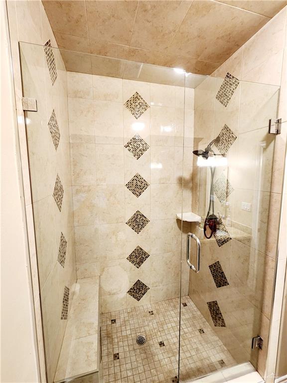 bathroom with a shower with door