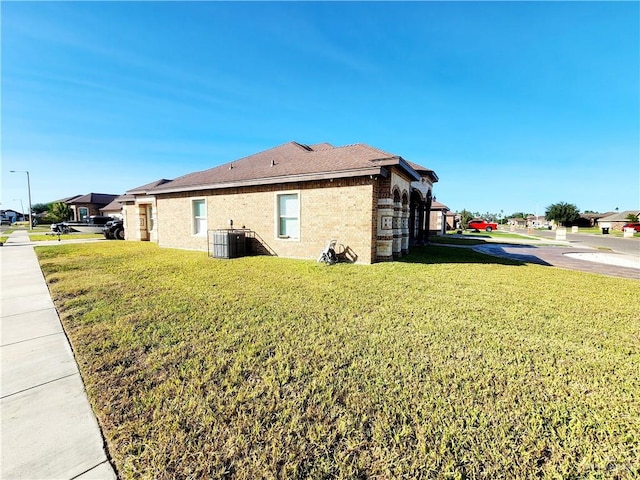 view of property exterior featuring central air condition unit and a lawn