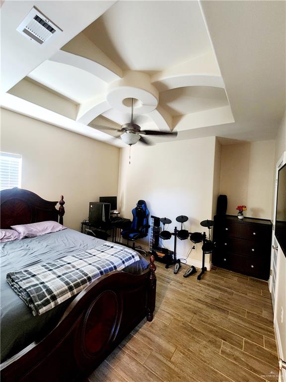 bedroom featuring wood-type flooring and ceiling fan