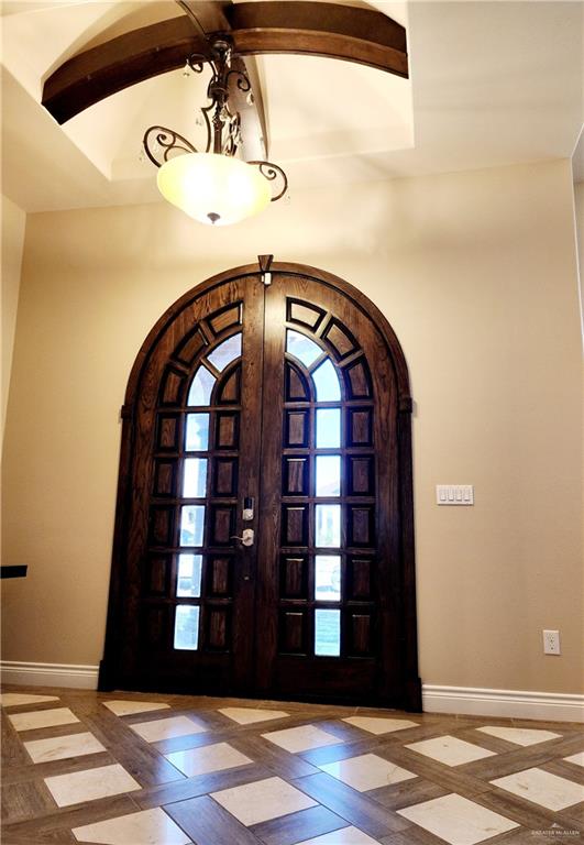 foyer with beamed ceiling and french doors