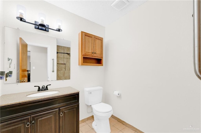 bathroom with vanity, toilet, and tile patterned flooring