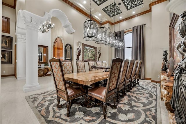 dining area featuring ornate columns, ornamental molding, a notable chandelier, and a towering ceiling