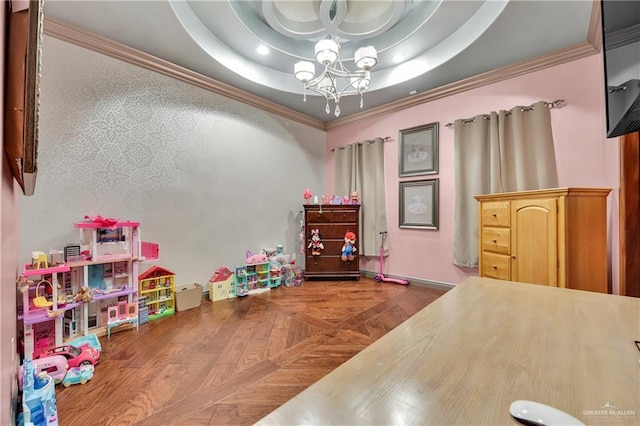 rec room featuring a tray ceiling, a chandelier, and crown molding
