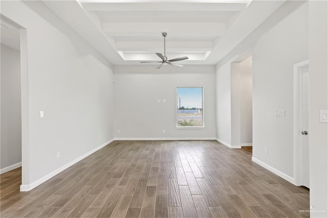 556 Candela St, Edinburg, TX 78542 - empty room featuring a tray ceiling, wood finished floors, and a ceiling fan