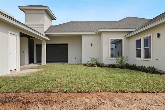 556 Candela St, Edinburg, TX 78542 - entrance to property featuring stucco siding, a yard, a shingled roof, and a garage