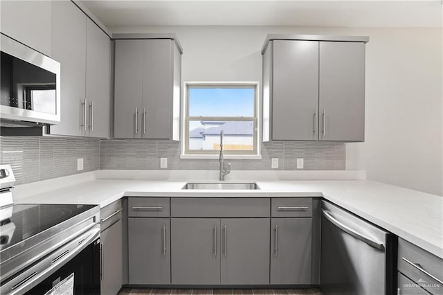 556 Candela St, Edinburg, TX 78542 - kitchen featuring gray cabinets, stainless steel appliances, and tasteful backsplash