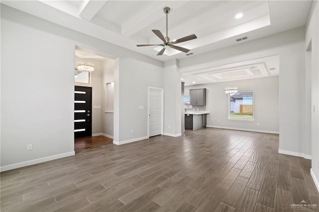 556 Candela St, Edinburg, TX 78542 - unfurnished living room featuring a chandelier, dark wood-type flooring, beam ceiling, a ceiling fan, and recessed lighting