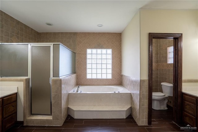 full bathroom featuring plus walk in shower, vanity, tile walls, and toilet