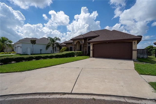 view of front facade with a front yard and a garage