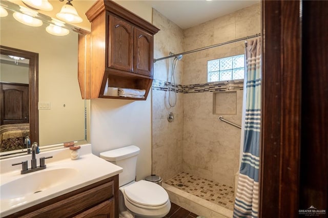 bathroom with vanity, toilet, and walk in shower