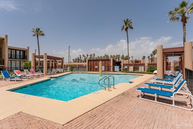 110 Padre Blvd Unit 603, South Padre Island, TX 78597 - community pool featuring a patio and fence