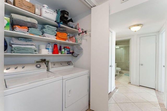 110 Padre Blvd Unit 603, South Padre Island, TX 78597 - washroom with light tile patterned floors, separate washer and dryer, and laundry area