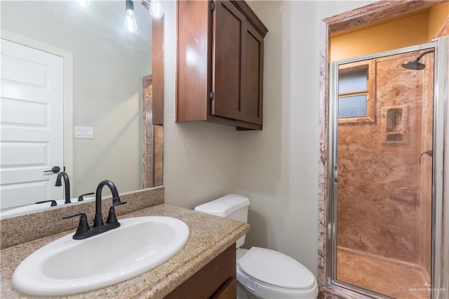 full bath featuring a shower stall, toilet, and vanity