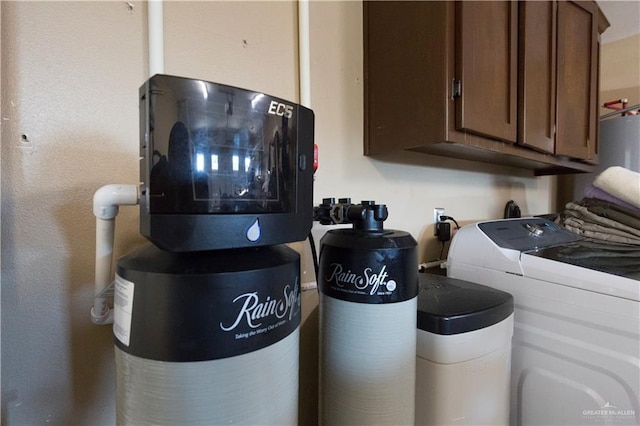 washroom with cabinet space and washer and dryer