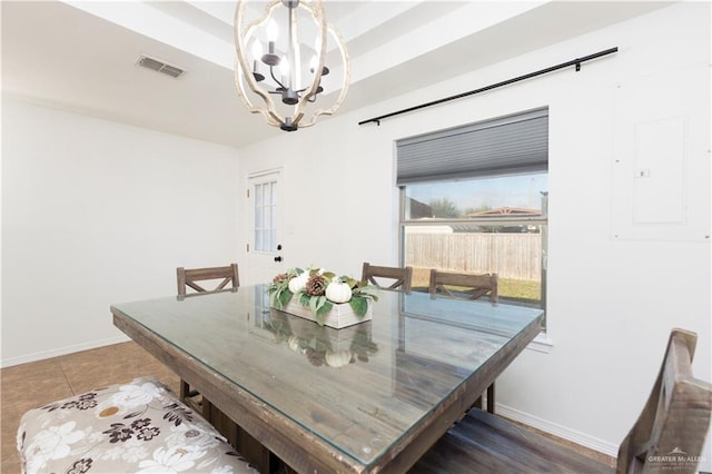 tiled dining space with baseboards, an inviting chandelier, visible vents, and electric panel