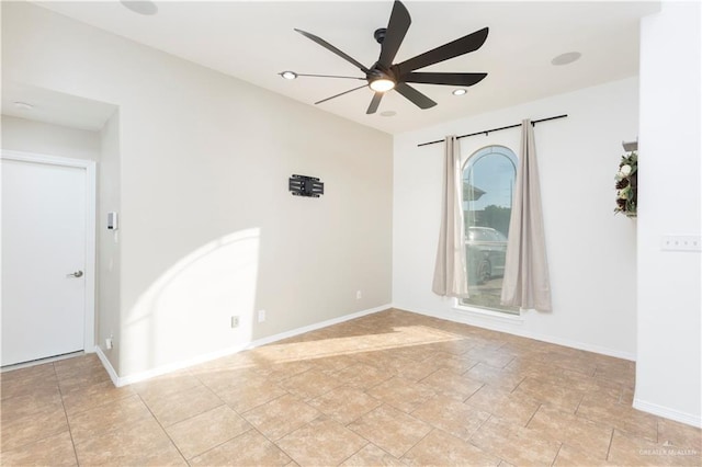 unfurnished room with ceiling fan and baseboards