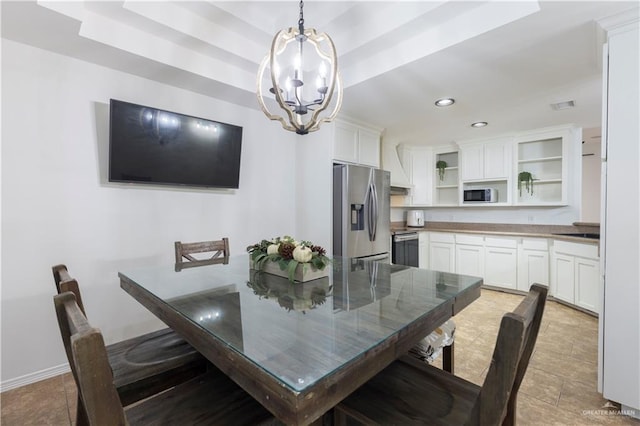 tiled dining space featuring recessed lighting, a notable chandelier, visible vents, baseboards, and a raised ceiling