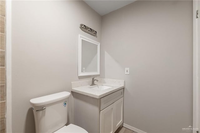 2310 Arbor St, Harlingen, TX 78552 - bathroom with vanity, toilet, and baseboards