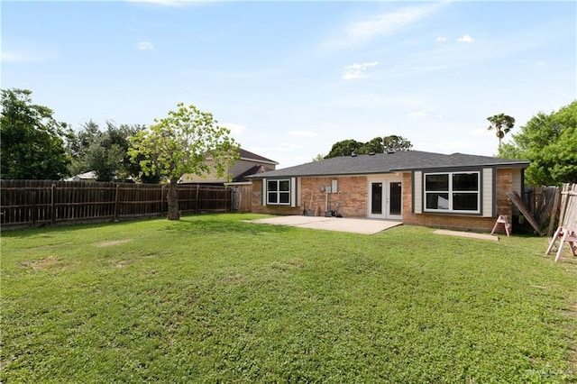 2310 Arbor St, Harlingen, TX 78552 - back of property featuring french doors, a patio area, and brick siding