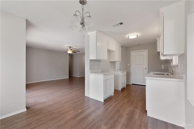 2310 Arbor St, Harlingen, TX 78552 - kitchen featuring ceiling fan, a sink, light countertops, open floor plan, and backsplash