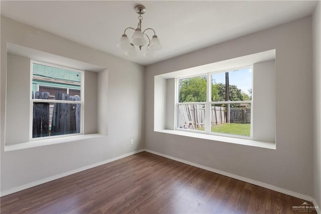 2310 Arbor St, Harlingen, TX 78552 - empty room featuring a chandelier, wood finished floors, and baseboards