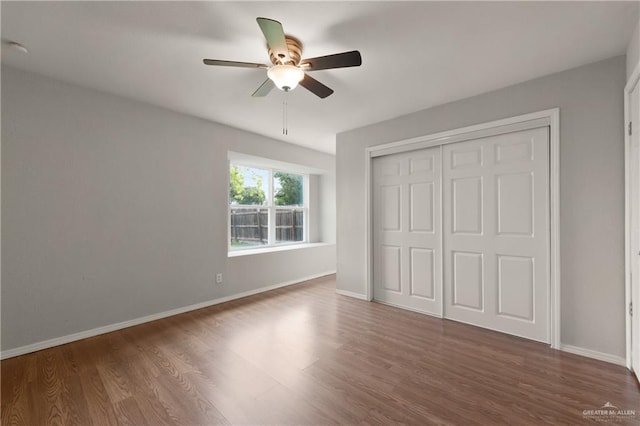2310 Arbor St, Harlingen, TX 78552 - unfurnished bedroom with wood finished floors, baseboards, a closet, and ceiling fan