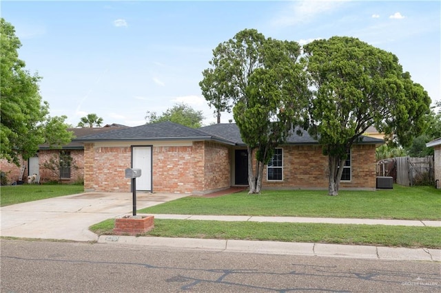 2310 Arbor St, Harlingen, TX 78552 - ranch-style home featuring central AC unit, brick siding, roof with shingles, and concrete driveway