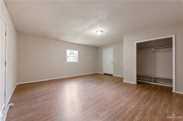 2310 Arbor St, Harlingen, TX 78552 - unfurnished bedroom featuring wood finished floors, baseboards, and a closet
