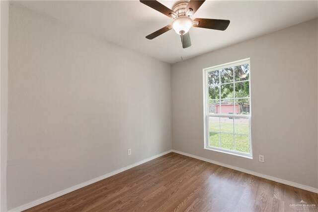 2310 Arbor St, Harlingen, TX 78552 - spare room with wood finished floors, baseboards, and a ceiling fan