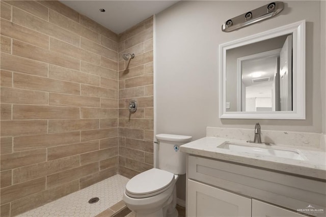 2310 Arbor St, Harlingen, TX 78552 - full bath with a tile shower, toilet, and vanity