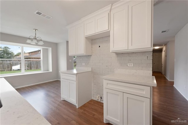 2310 Arbor St, Harlingen, TX 78552 - kitchen featuring dark wood-style floors, a chandelier, white cabinets, and baseboards