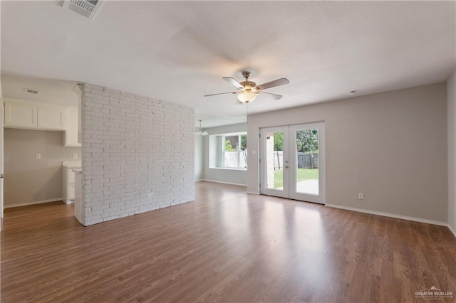 2310 Arbor St, Harlingen, TX 78552 - unfurnished living room featuring ceiling fan, wood finished floors, baseboards, and french doors