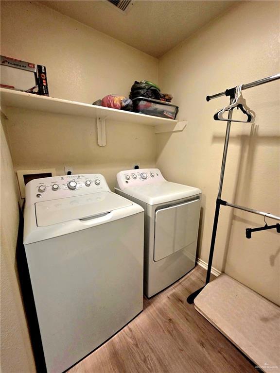 1920 Katherine Ave, Edinburg, TX 78539 - washroom with light wood-style flooring and independent washer and dryer