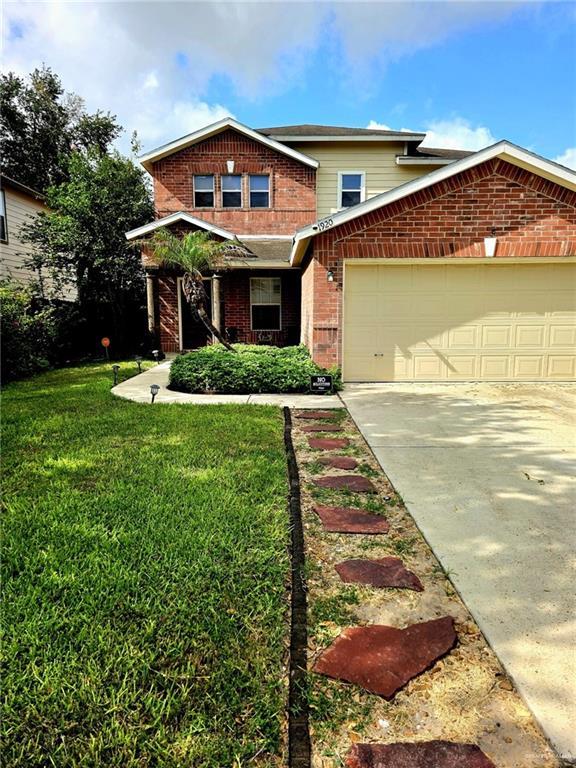 1920 Katherine Ave, Edinburg, TX 78539 - view of front of property with brick siding, a garage, concrete driveway, and a front lawn