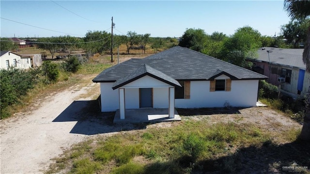 4630 Western Rd, Mission, TX 78574 - exterior space featuring a patio, roof with shingles, and stucco siding