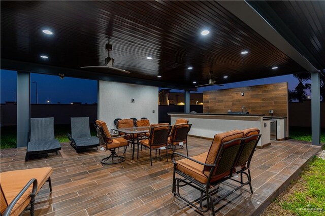 view of patio / terrace with ceiling fan and sink