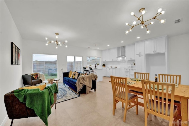 dining space featuring visible vents and a notable chandelier