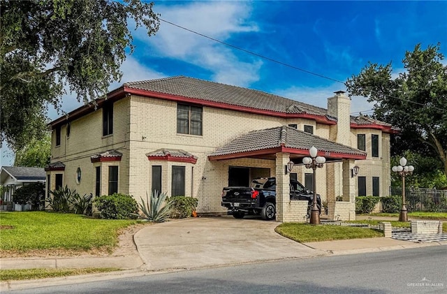 1712 N 1st St, Mcallen, TX 78501 - view of front of home with a tile roof, a carport, driveway, brick siding, and a front yard