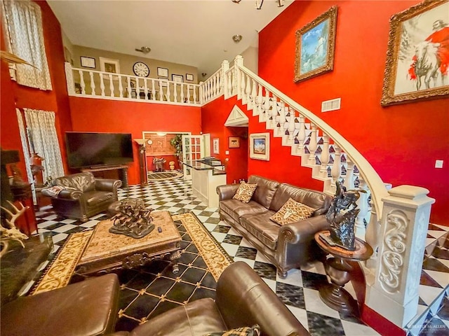 1712 N 1st St, Mcallen, TX 78501 - living room with visible vents, tile patterned floors, a high ceiling, and stairway