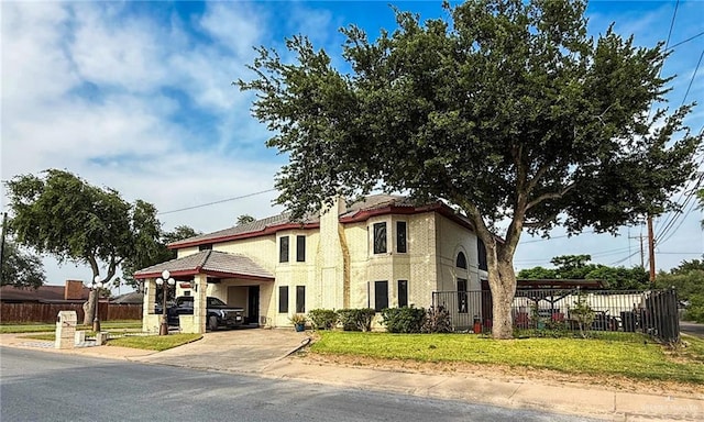 1712 N 1st St, Mcallen, TX 78501 - mediterranean / spanish-style house featuring fence, driveway, a carport, and stucco siding