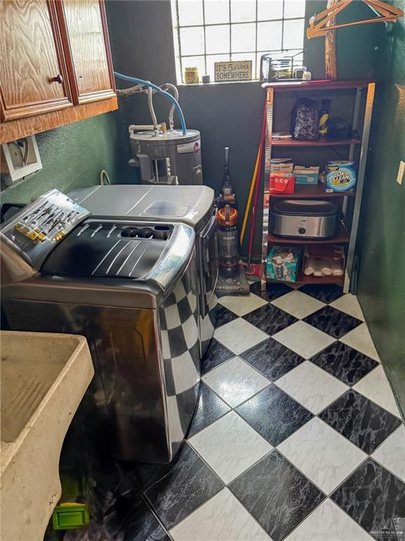 1712 N 1st St, Mcallen, TX 78501 - clothes washing area with cabinet space, water heater, and washer and dryer