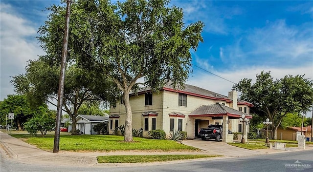 1712 N 1st St, Mcallen, TX 78501 - view of front of home featuring driveway, a chimney, a front yard, and brick siding