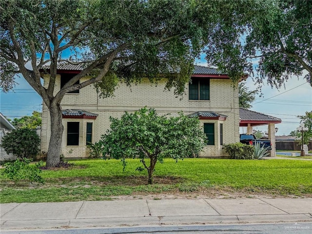 1712 N 1st St, Mcallen, TX 78501 - view of front of property with brick siding, a front lawn, and a carport