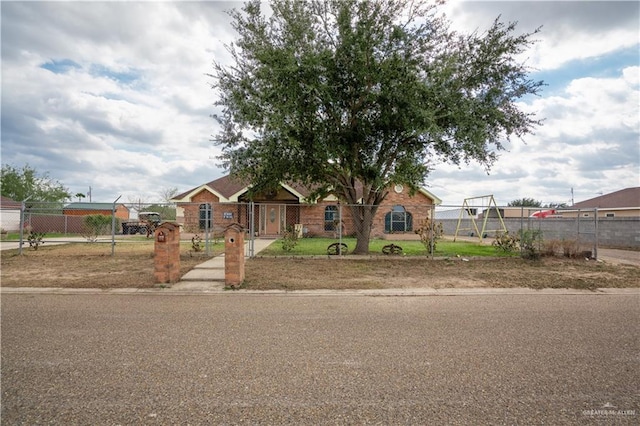 view of front of property featuring a fenced front yard and a gate