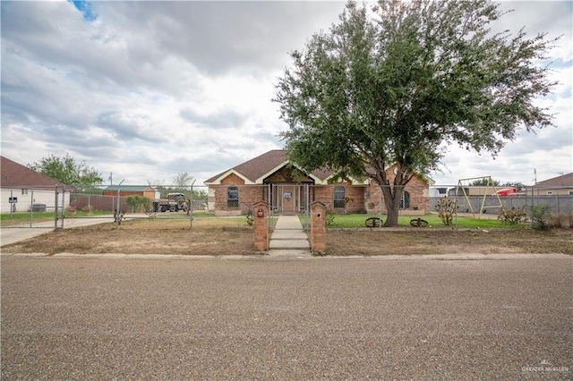 ranch-style home featuring a fenced front yard and a gate