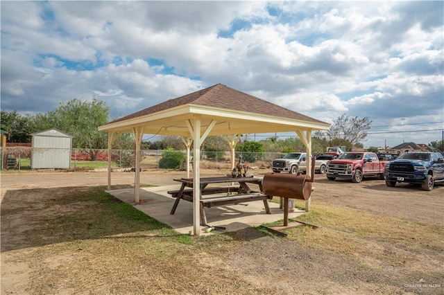 surrounding community with an outbuilding, fence, a gazebo, and a shed