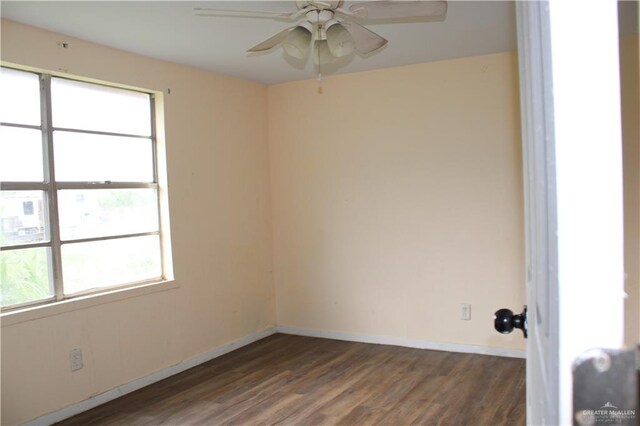 spare room featuring dark hardwood / wood-style floors and ceiling fan