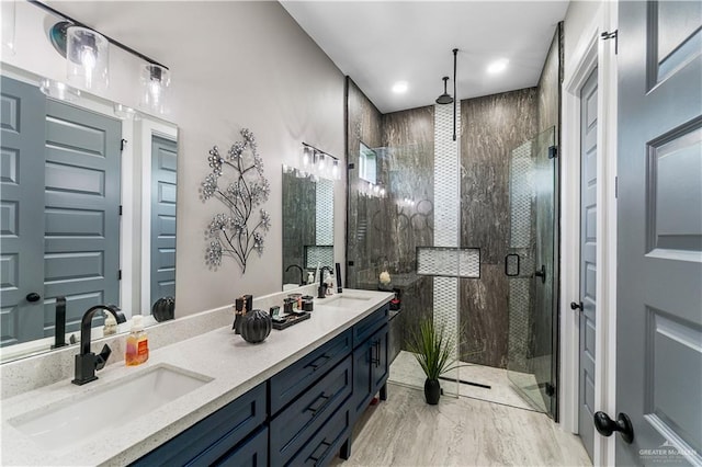 bathroom with walk in shower and vanity